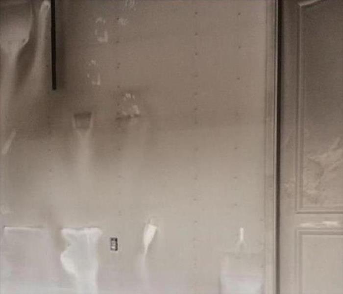 sooty film on walls and door in garage