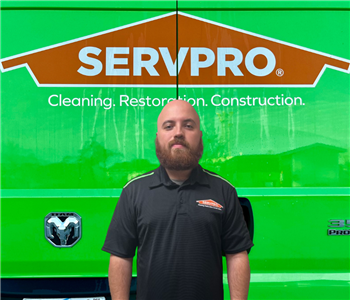 Man in front of Servpro Sign