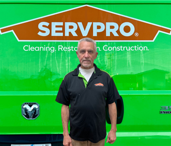 Man in front of Servpro Sign