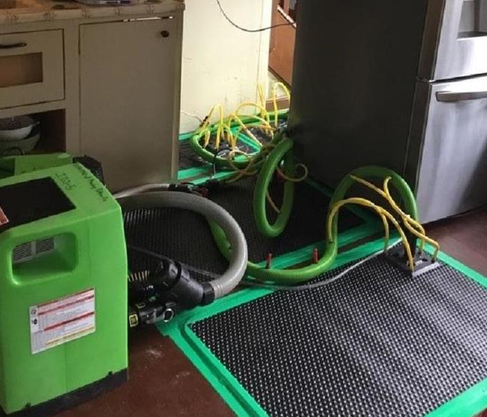 green dehumidifier, drying mat black in kitchen