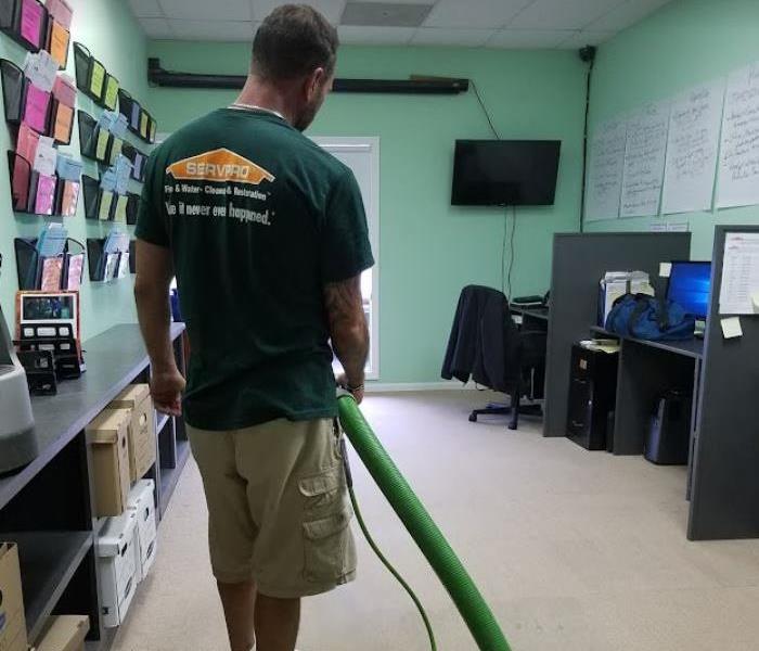 SERVPRO tech removing water from inside office